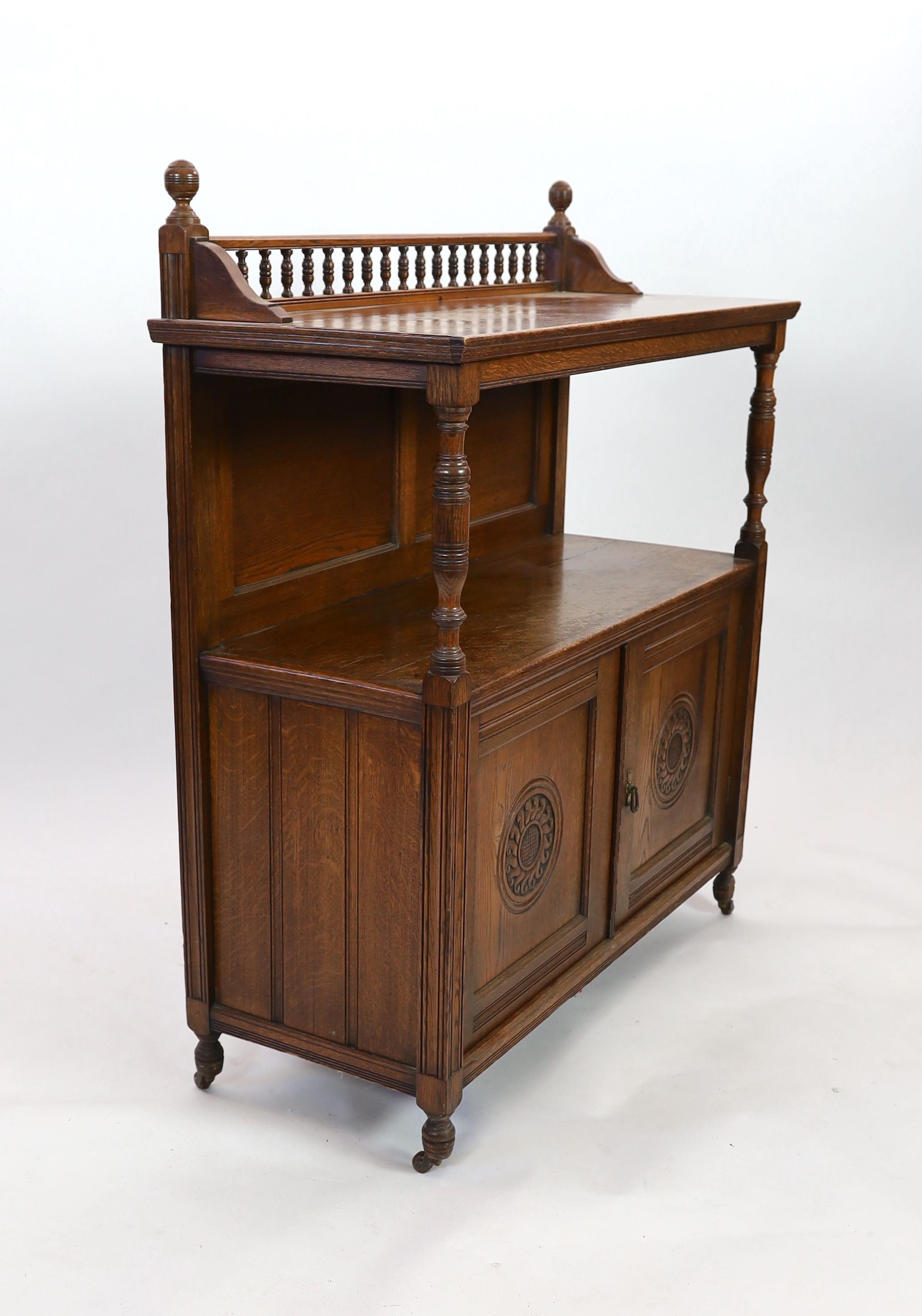 A late Victorian oak buffet, width 113cm depth 47cm height 133cm